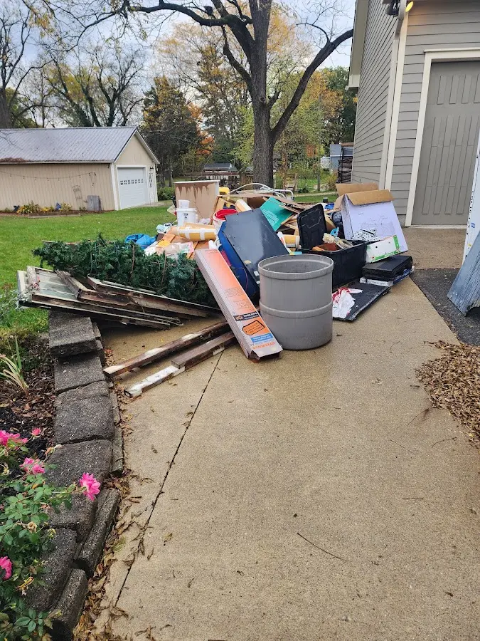 Dumpster being loaded with debris for Roofing Dumpster Rental in Boston